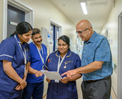 Staff in discussion over a file