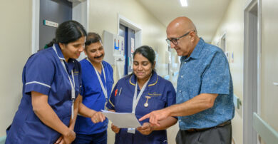 Staff in discussion over a file