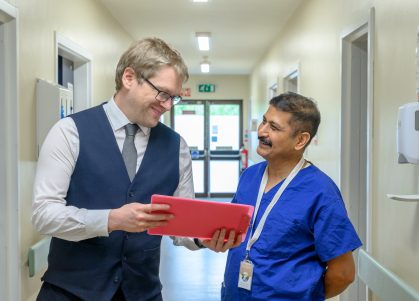 Staff in discussion over a folder