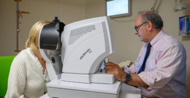 A consultant tests a patient's vision