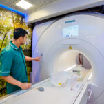 An MRI technician operates the MRI machine