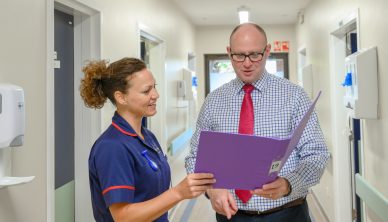 Consultant and nurse discuss a patient's file