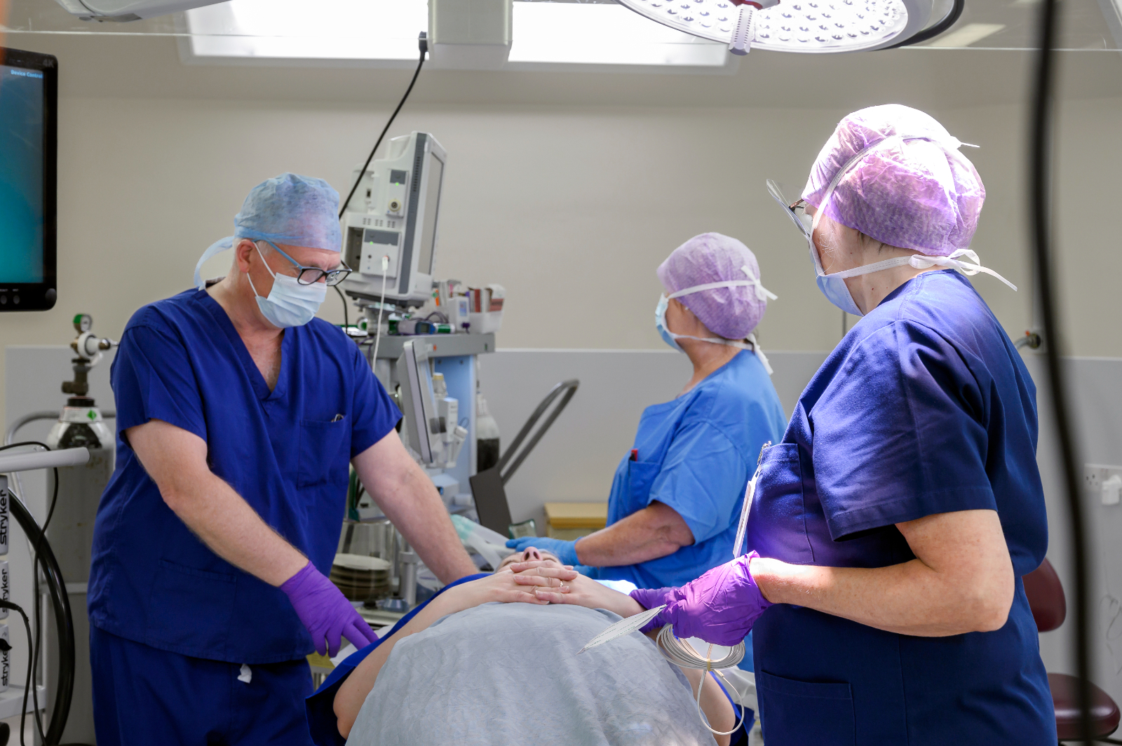 Surgeons treating a patient in theatre